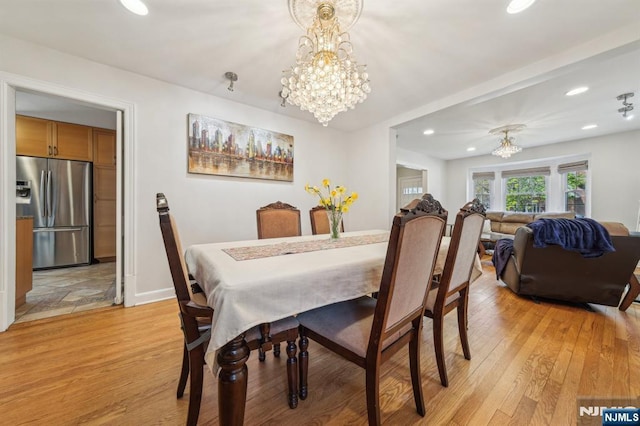 dining area with recessed lighting, baseboards, light wood-style floors, and a chandelier