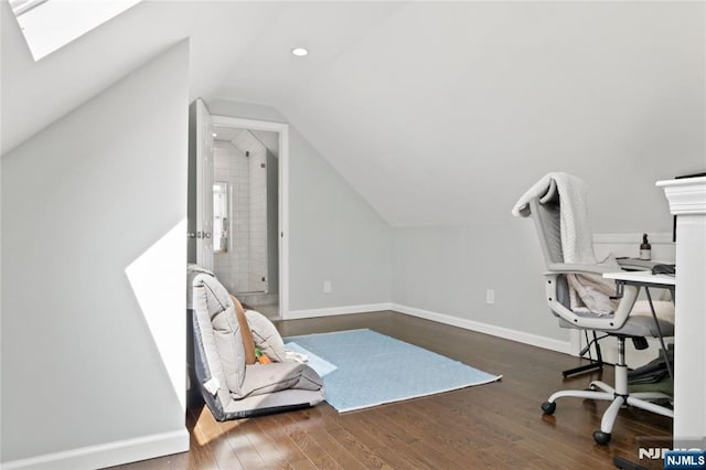 office area featuring baseboards, wood finished floors, and lofted ceiling with skylight