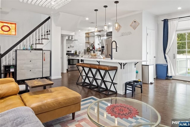 living room featuring ornamental molding, stairs, baseboards, dark wood-style floors, and recessed lighting
