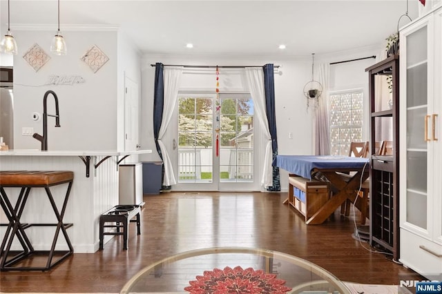interior space with recessed lighting, ornamental molding, and dark wood finished floors