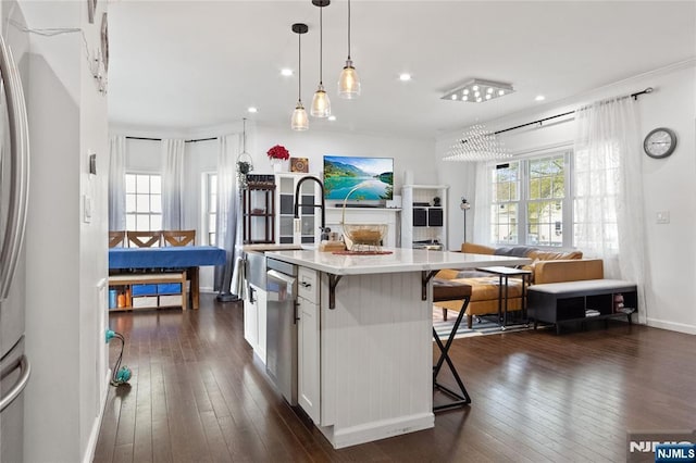 kitchen with a kitchen breakfast bar, dishwasher, light countertops, dark wood-style floors, and an island with sink