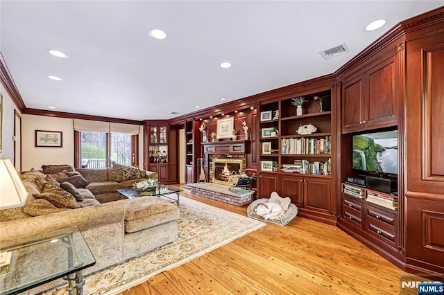 living room featuring recessed lighting, light wood finished floors, visible vents, and crown molding
