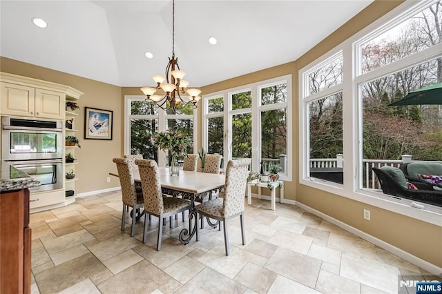 dining area with stone finish floor, baseboards, recessed lighting, and a notable chandelier