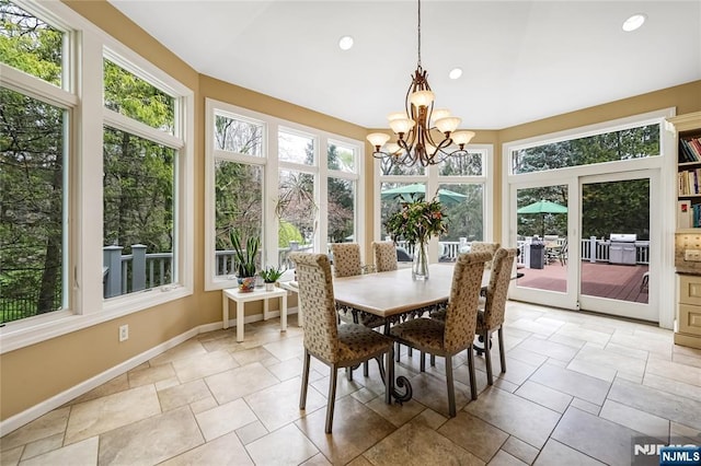 sunroom with a chandelier, baseboards, and recessed lighting