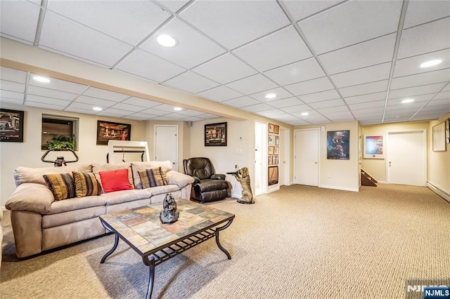carpeted living room featuring a paneled ceiling, baseboards, and recessed lighting