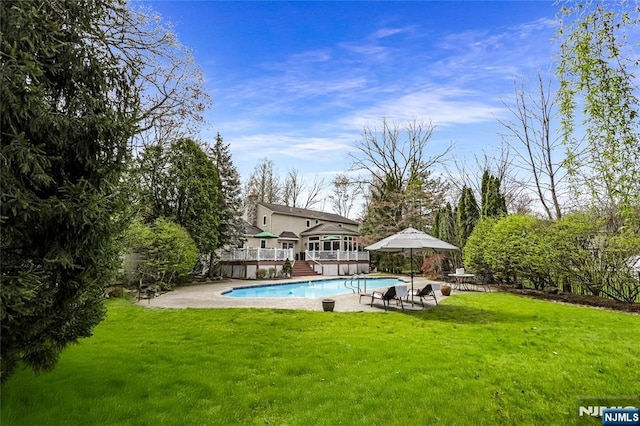 view of swimming pool with a yard, a fenced in pool, a patio, and a deck