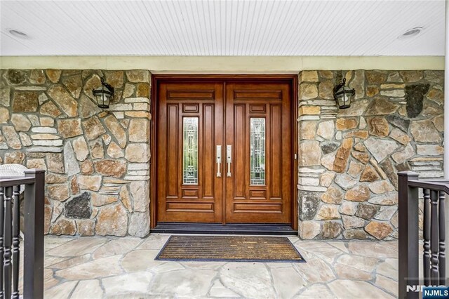 view of exterior entry featuring stone siding