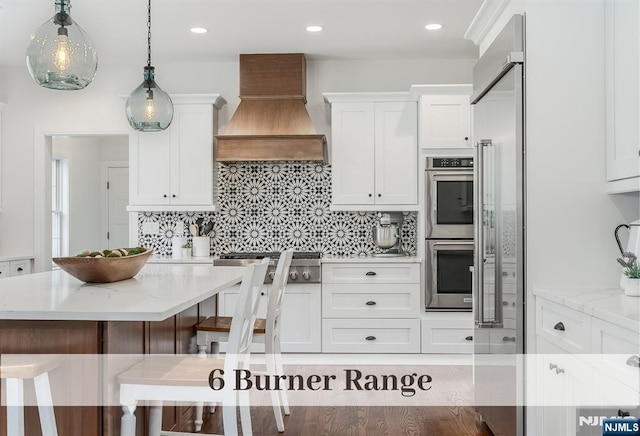 21 Flintlock Rd, Montvale, NJ 07645 - kitchen with appliances with stainless steel finishes, decorative backsplash, custom range hood, and white cabinetry