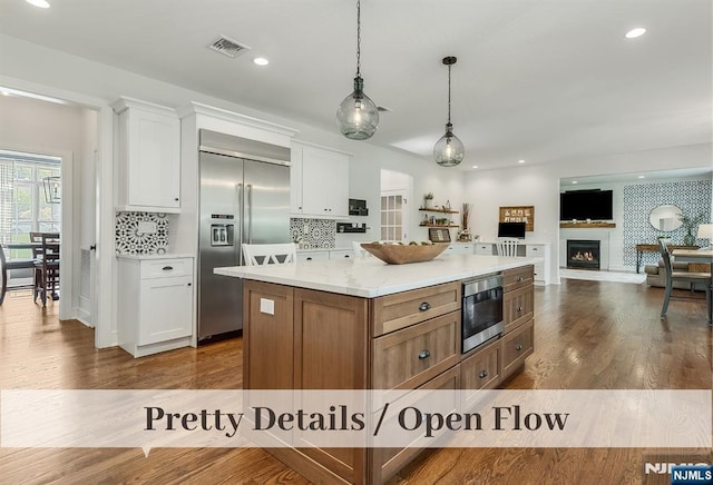 21 Flintlock Rd, Montvale, NJ 07645 - kitchen featuring light countertops, built in appliances, white cabinetry, and visible vents