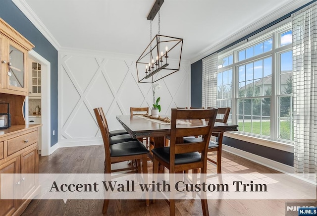 21 Flintlock Rd, Montvale, NJ 07645 - dining room with wood finished floors, baseboards, a chandelier, ornamental molding, and a decorative wall