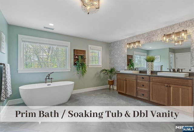21 Flintlock Rd, Montvale, NJ 07645 - full bath featuring double vanity, visible vents, a sink, a chandelier, and a soaking tub