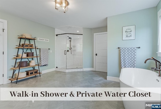 21 Flintlock Rd, Montvale, NJ 07645 - bathroom with a freestanding tub, a stall shower, a sink, baseboards, and tile patterned floors