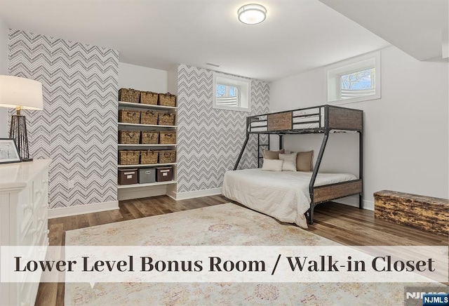 21 Flintlock Rd, Montvale, NJ 07645 - bedroom with baseboards, wallpapered walls, wood finished floors, and an accent wall