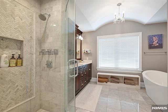 bathroom with baseboards, tiled shower, and vanity