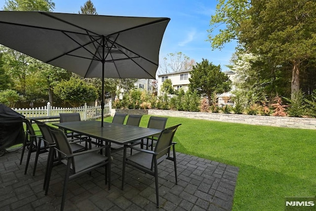 view of patio / terrace featuring fence and outdoor dining area