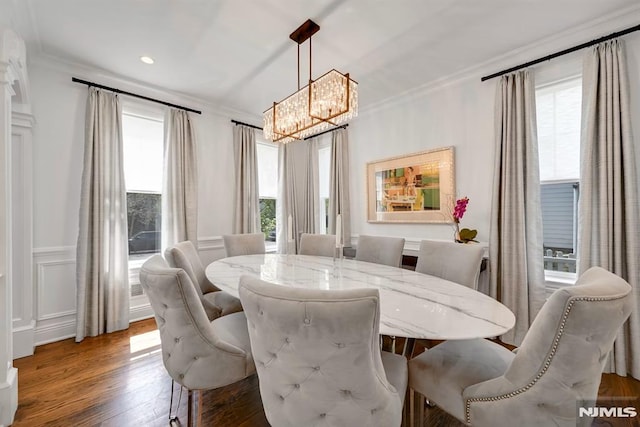 dining space featuring ornamental molding, a chandelier, recessed lighting, and wood finished floors
