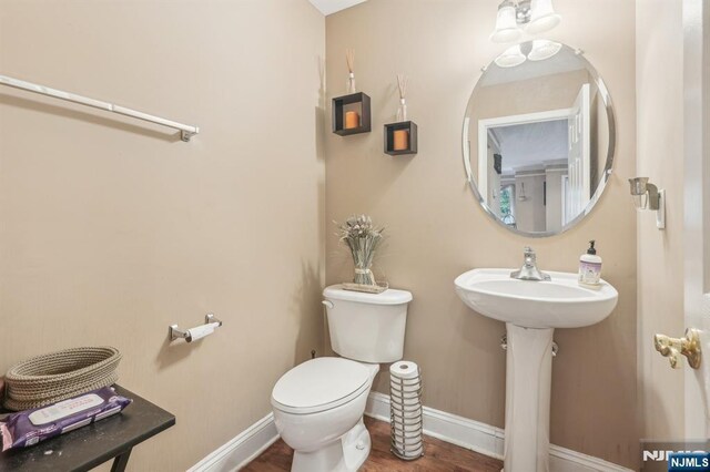 150 Blue Heron Dr, Secaucus, NJ 07094 - bathroom with toilet, wood finished floors, and baseboards