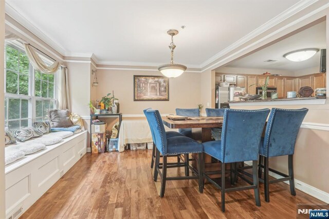 150 Blue Heron Dr, Secaucus, NJ 07094 - dining room with light wood-type flooring and crown molding