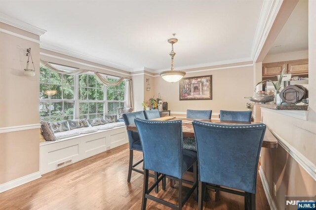 150 Blue Heron Dr, Secaucus, NJ 07094 - dining area featuring crown molding and light wood-type flooring
