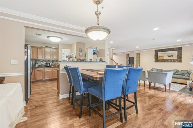 150 Blue Heron Dr, Secaucus, NJ 07094 - dining area featuring ornamental molding, light wood-style flooring, and recessed lighting