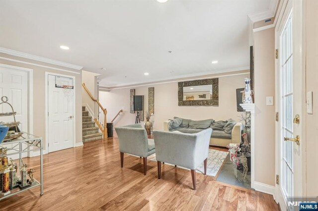 150 Blue Heron Dr, Secaucus, NJ 07094 - living room featuring stairway, crown molding, recessed lighting, light wood-type flooring, and baseboards