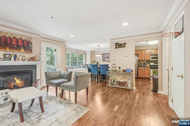 150 Blue Heron Dr, Secaucus, NJ 07094 - living room with crown molding, light wood-style flooring, a glass covered fireplace, and recessed lighting