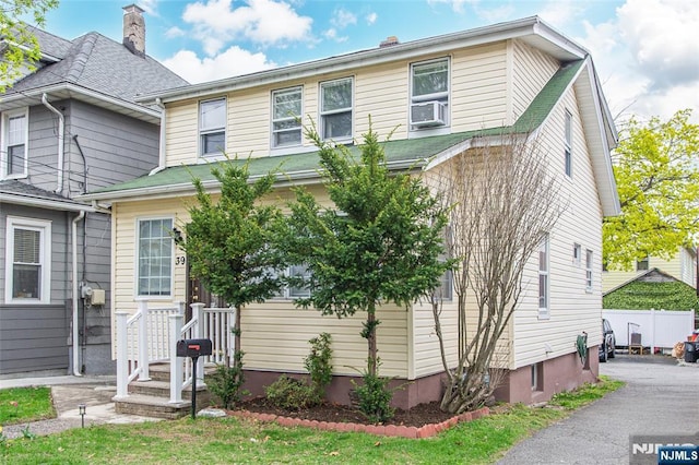 view of front of house featuring a chimney