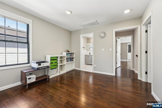 miscellaneous room featuring recessed lighting, baseboards, visible vents, and wood finished floors