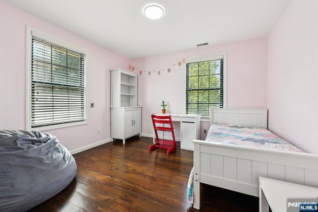 bedroom featuring dark wood-style flooring, baseboards, and visible vents