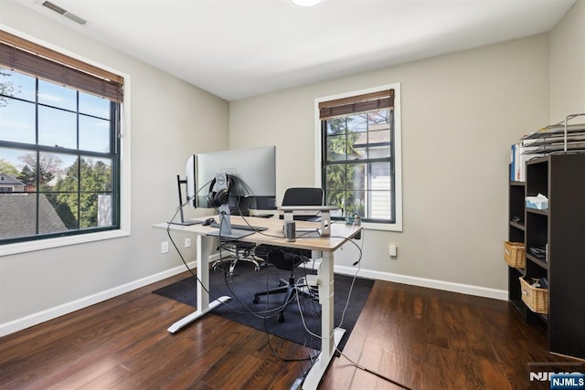 office area with baseboards, wood finished floors, and visible vents