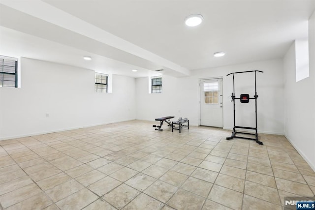 exercise area with baseboards, recessed lighting, and light tile patterned flooring