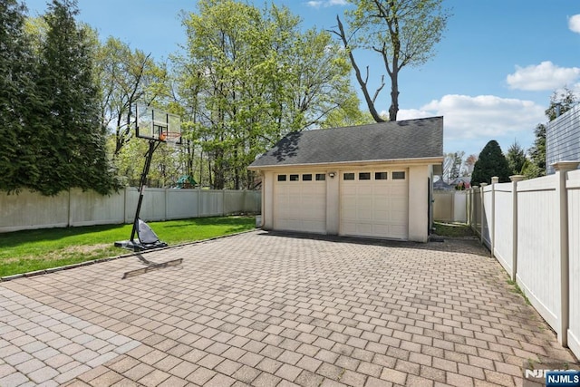 detached garage featuring fence