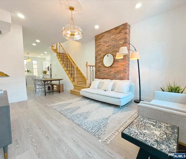 living area featuring recessed lighting, stairway, an inviting chandelier, wood finished floors, and baseboards