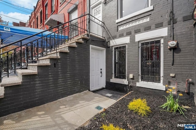 property entrance with brick siding