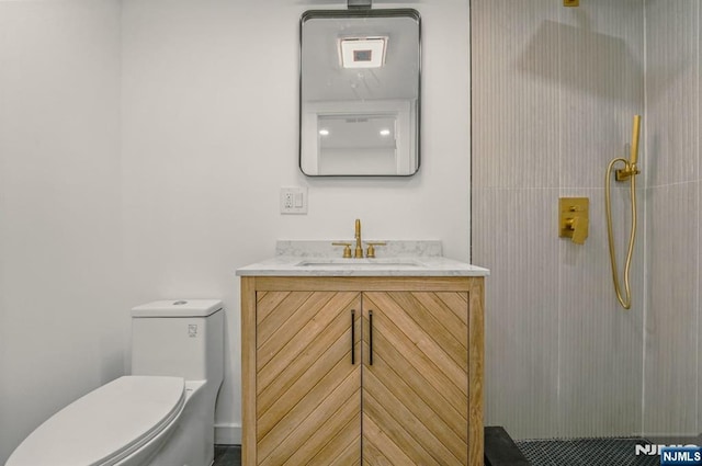 full bath featuring toilet, a shower, and vanity