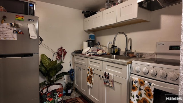 kitchen featuring a sink, extractor fan, white cabinetry, and appliances with stainless steel finishes
