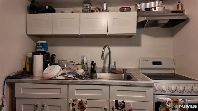 kitchen featuring electric range, white cabinetry, under cabinet range hood, and a sink