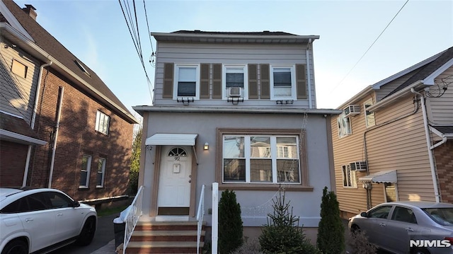 view of front of home with cooling unit and stucco siding