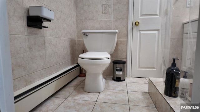 bathroom featuring tile walls, tile patterned flooring, baseboard heating, and toilet