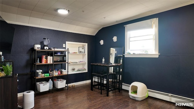 miscellaneous room featuring a baseboard heating unit, lofted ceiling, wood finished floors, and baseboards
