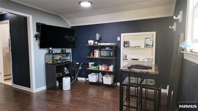 office area with a baseboard radiator, wood finished floors, baseboards, and ornamental molding