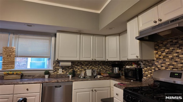kitchen with white cabinets, dark countertops, appliances with stainless steel finishes, and under cabinet range hood