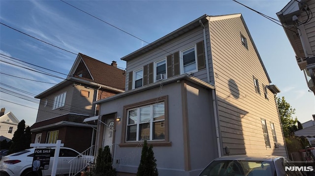 view of side of property with stucco siding and cooling unit