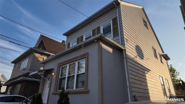 view of side of home with stucco siding