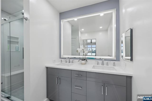 7400 River Rd Unit 431, North Bergen, NJ 07047 - bathroom with double vanity, a shower stall, and recessed lighting