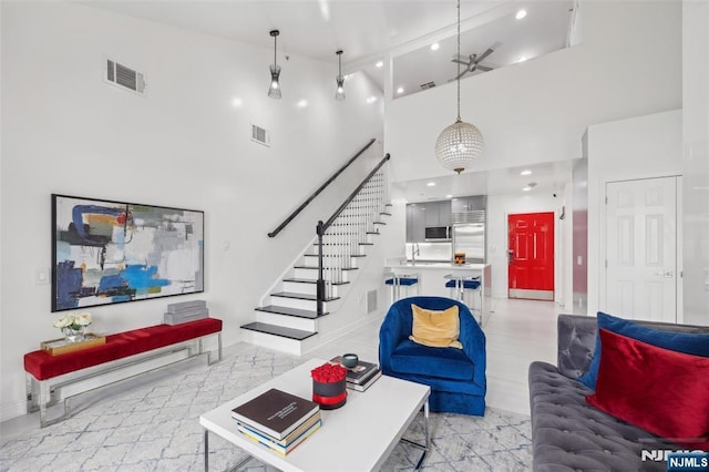7400 River Rd Unit 431, North Bergen, NJ 07047 - living area with high vaulted ceiling, stairs, baseboards, and recessed lighting