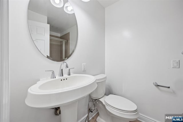 7400 River Rd Unit 431, North Bergen, NJ 07047 - full bathroom featuring toilet, a shower with door, and a sink