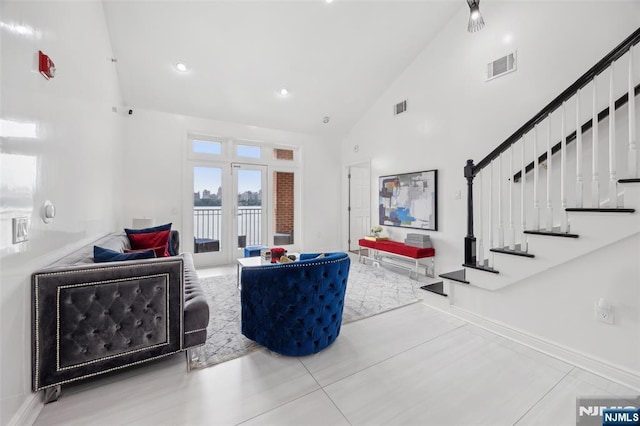 7400 River Rd Unit 431, North Bergen, NJ 07047 - living area with high vaulted ceiling, stairway, a water view, baseboards, and french doors