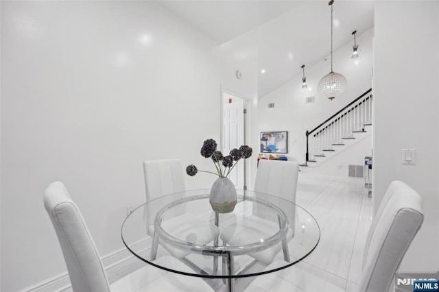 7400 River Rd Unit 431, North Bergen, NJ 07047 - dining room with stairs, baseboards, high vaulted ceiling, and light tile patterned floors