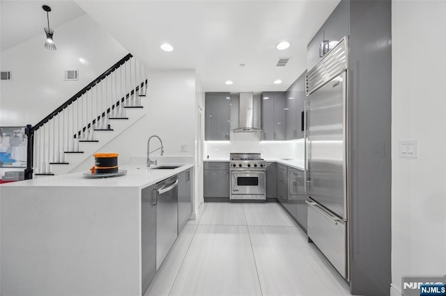 7400 River Rd Unit 431, North Bergen, NJ 07047 - kitchen with premium appliances, gray cabinetry, modern cabinets, wall chimney exhaust hood, and a peninsula